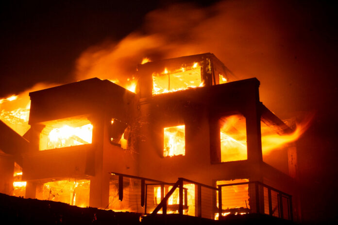 Palisades fire burns during a windstorm on the west side of Los Angeles